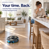 HavenSweep cleaning a kitchen floor while a woman enjoys coffee at the island.