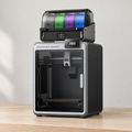 Formridge X4 printer and four-slot CFS on a light wood workbench, with the build plate visible through the closed front door.