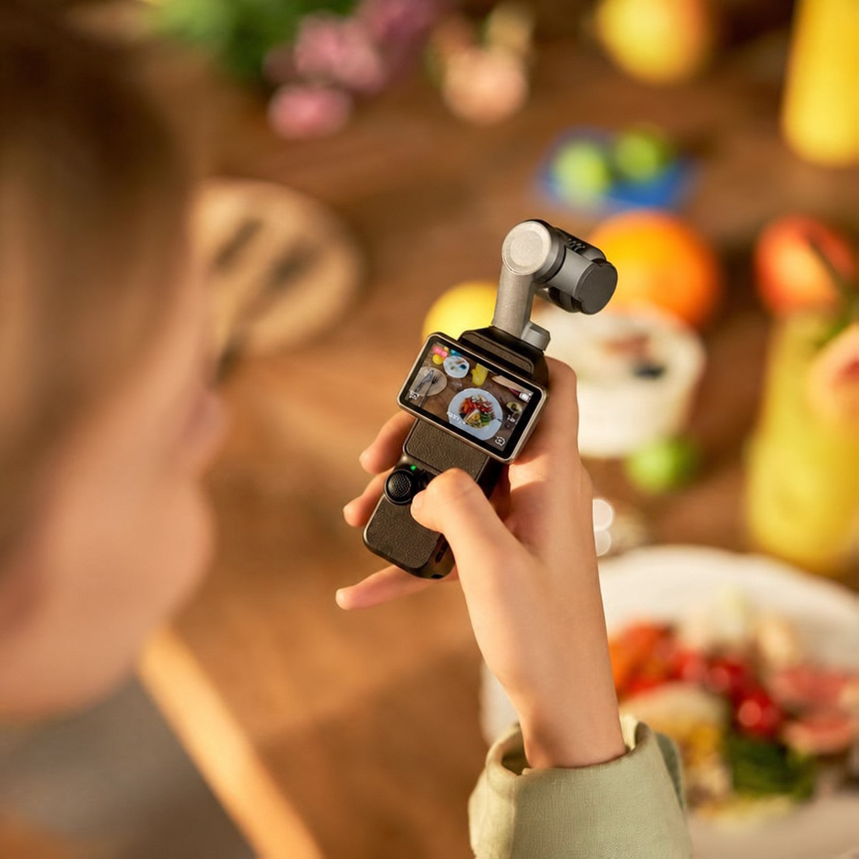 Woman filming food on a table with Daynori Pocket.