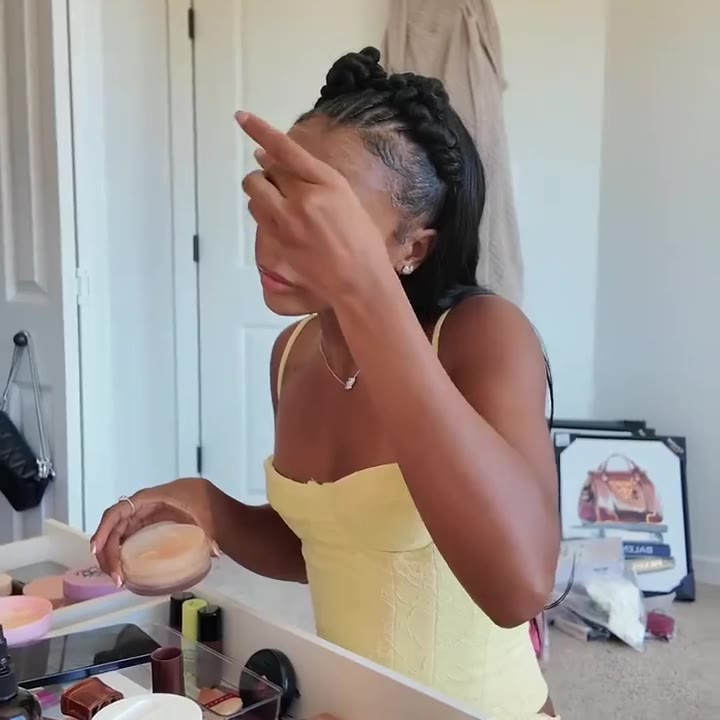 Woman recording her makeup routine.